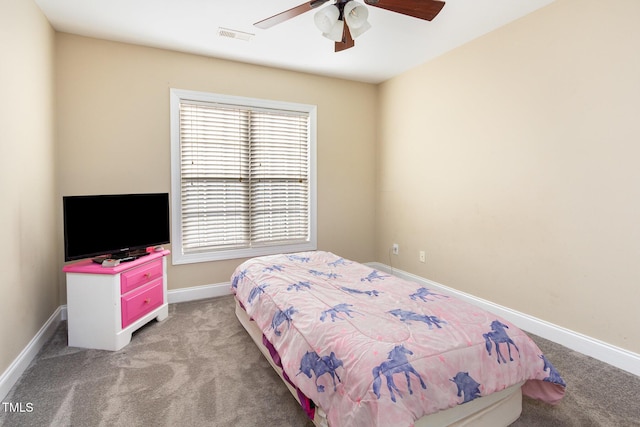 bedroom featuring baseboards, multiple windows, ceiling fan, and light carpet