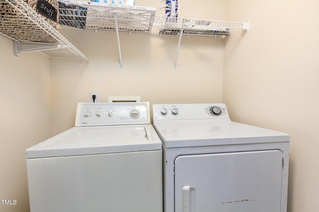clothes washing area with laundry area and independent washer and dryer