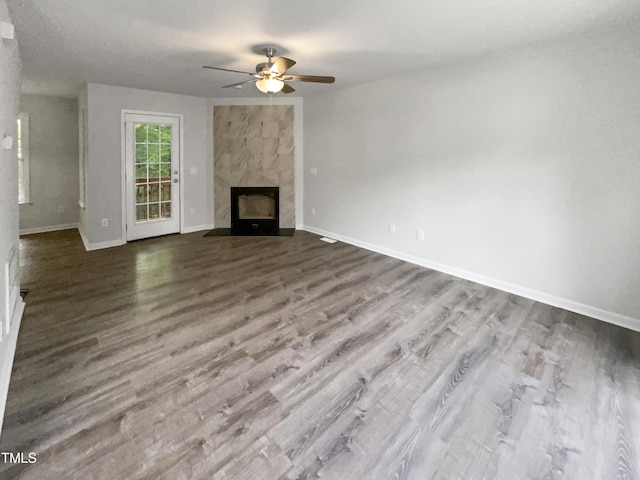 517 Hidden Cellars Dr, Holly Springs, NC 27540 - unfurnished living room with a high end fireplace, baseboards, ceiling fan, and dark wood-type flooring