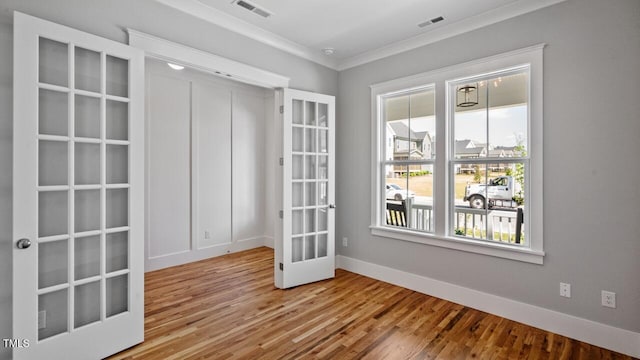 1733 Birdhaven Ln Lot 2217, Wendell, NC 27591 - spare room with french doors, crown molding, wood finished floors, and a smoke detector