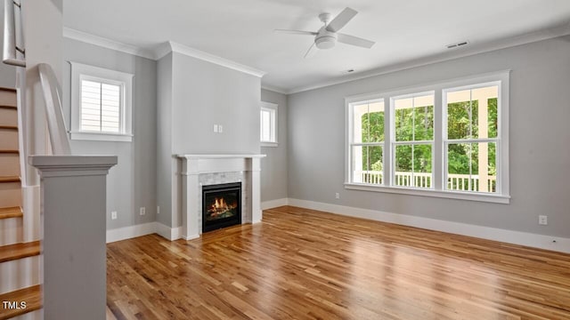 1733 Birdhaven Ln Lot 2217, Wendell, NC 27591 - unfurnished living room with stairs, wood finished floors, ornamental molding, a ceiling fan, and a tile fireplace