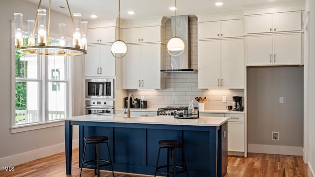 1733 Birdhaven Ln Lot 2217, Wendell, NC 27591 - kitchen featuring wall chimney range hood, light wood-type flooring, decorative backsplash, light countertops, and white cabinets