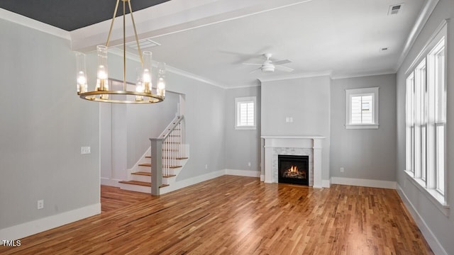 1733 Birdhaven Ln Lot 2217, Wendell, NC 27591 - unfurnished living room with wood finished floors, crown molding, plenty of natural light, ceiling fan, and a lit fireplace