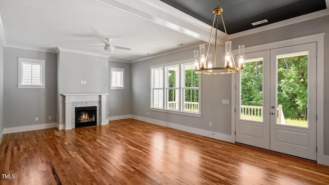 1733 Birdhaven Ln Lot 2217, Wendell, NC 27591 - unfurnished living room with plenty of natural light, wood finished floors, french doors, ornamental molding, and a glass covered fireplace