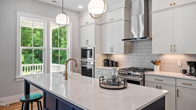 1733 Birdhaven Ln Lot 2217, Wendell, NC 27591 - kitchen with wall chimney exhaust hood, stainless steel appliances, backsplash, a center island with sink, and white cabinetry
