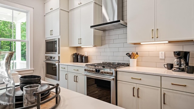1733 Birdhaven Ln Lot 2217, Wendell, NC 27591 - kitchen with stainless steel appliances, wall chimney range hood, healthy amount of natural light, and decorative backsplash