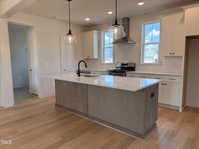 1720 Bright Lantern Way, Wendell, NC 27591 - kitchen featuring stainless steel range oven, wall chimney range hood, light wood finished floors, and recessed lighting