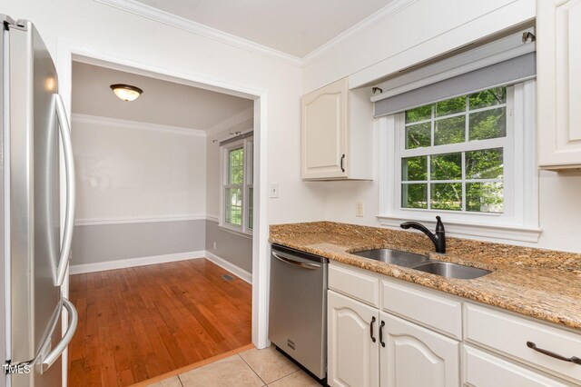 200 Weybossett Rd, Henderson, NC 27537 - kitchen featuring appliances with stainless steel finishes, ornamental molding, a sink, and a healthy amount of sunlight