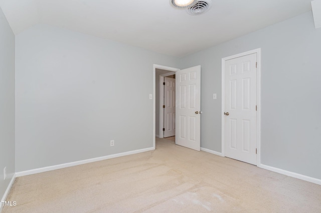 200 Weybossett Rd, Henderson, NC 27537 - unfurnished bedroom with carpet flooring, baseboards, visible vents, and lofted ceiling