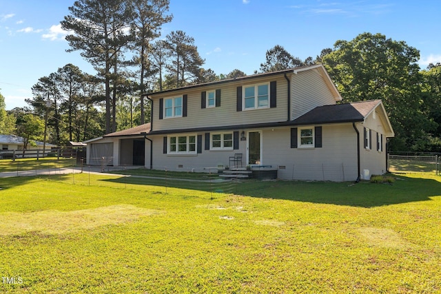 view of front of house with a garage, fence, and a front yard