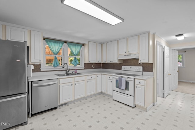 kitchen featuring under cabinet range hood, a wealth of natural light, a sink, light countertops, and appliances with stainless steel finishes