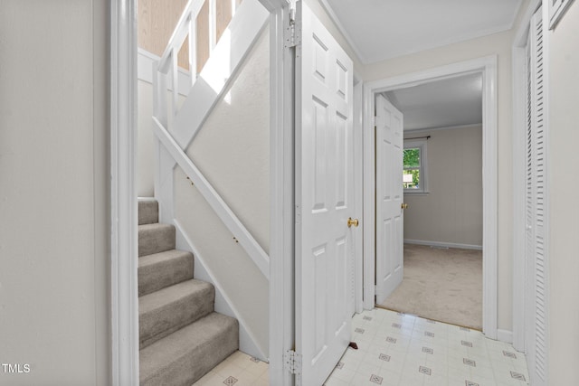 stairway with carpet, baseboards, and tile patterned floors