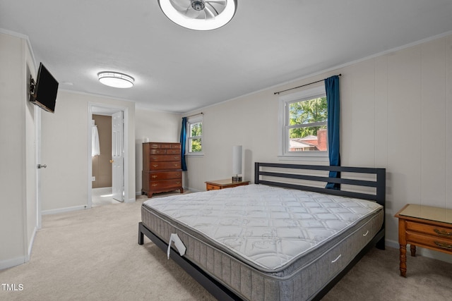 carpeted bedroom with ensuite bath and baseboards