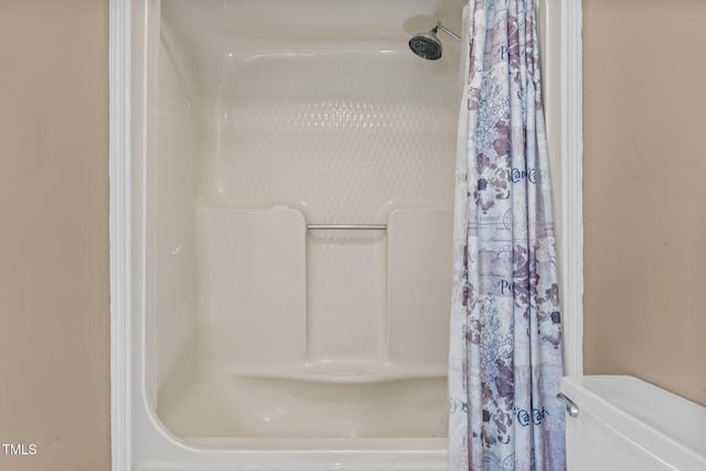 bathroom with toilet and a shower with shower curtain