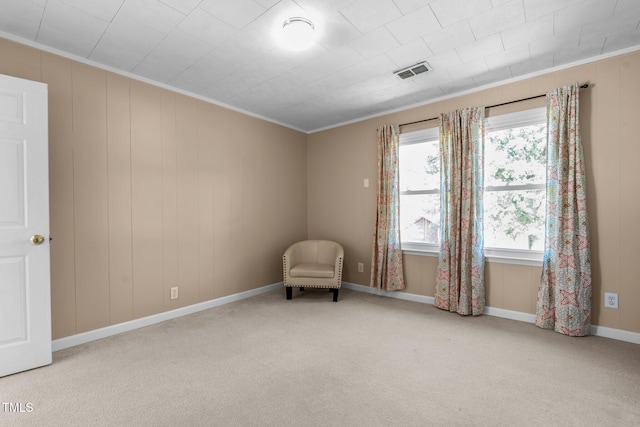unfurnished room featuring ornamental molding, carpet floors, baseboards, and visible vents