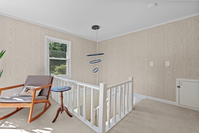 interior space with ornamental molding, carpet floors, and an upstairs landing