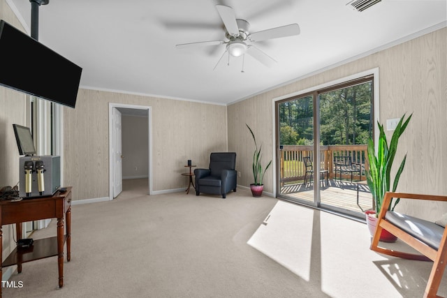 sitting room featuring ornamental molding, visible vents, carpet flooring, a ceiling fan, and baseboards