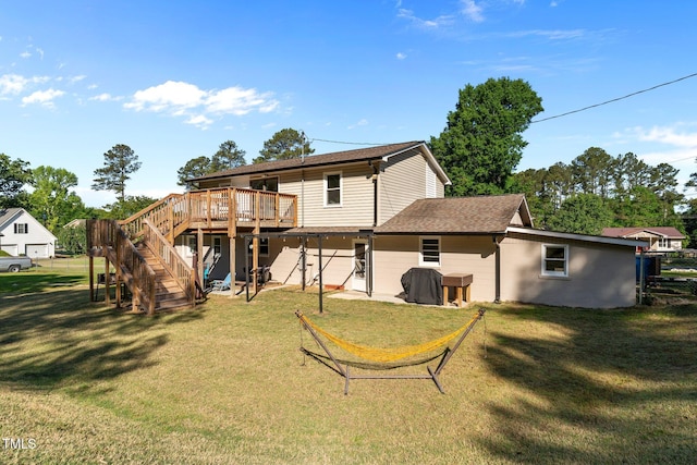 rear view of property with a yard, a deck, and stairway