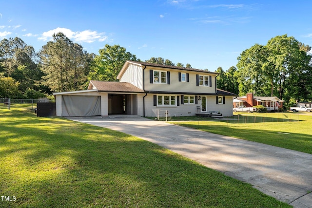 colonial house featuring concrete driveway, a front yard, fence, and a garage