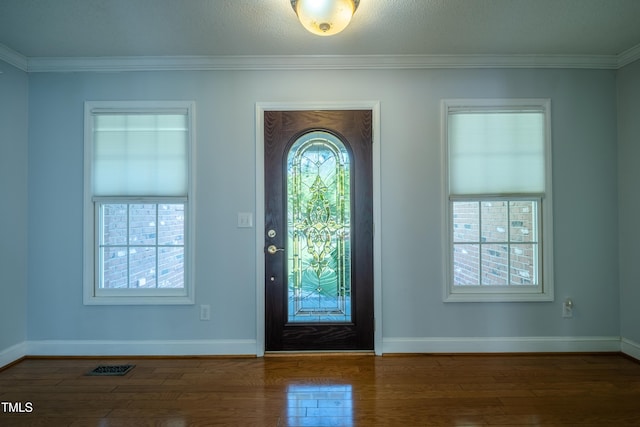 entryway featuring baseboards, ornamental molding, and wood finished floors
