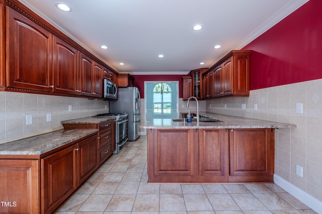 kitchen with a sink, appliances with stainless steel finishes, light stone countertops, and glass insert cabinets