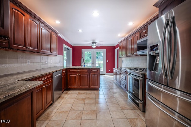 kitchen featuring french doors, backsplash, a peninsula, ornamental molding, and stainless steel appliances