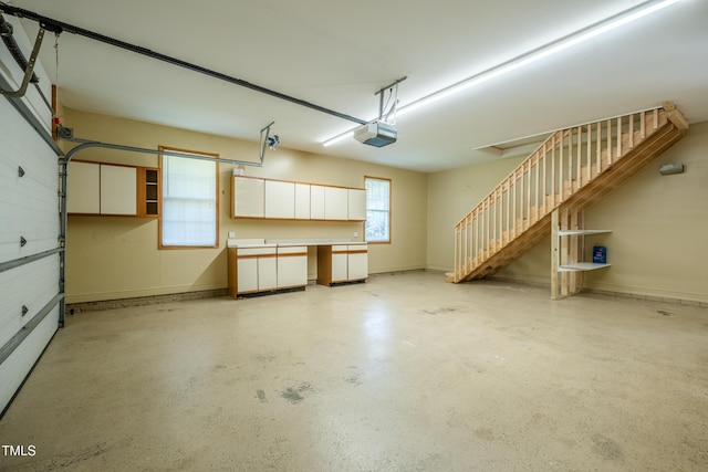 garage featuring baseboards and a garage door opener