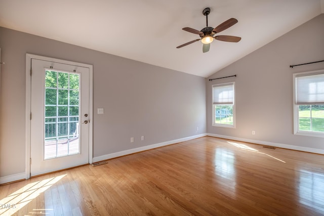 spare room with ceiling fan, baseboards, wood finished floors, lofted ceiling, and visible vents