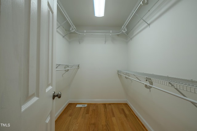 spacious closet featuring light wood finished floors and visible vents