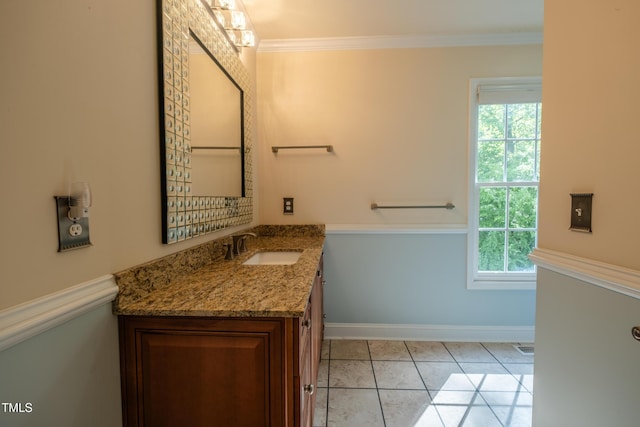 bathroom featuring vanity, baseboards, and a healthy amount of sunlight