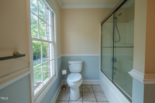 bathroom featuring baseboards, tile patterned floors, a wealth of natural light, and toilet