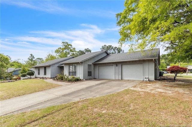 single story home with a front lawn, driveway, an attached garage, and board and batten siding