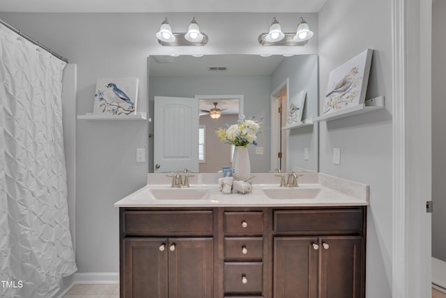 bathroom with visible vents, a sink, tile patterned flooring, and double vanity
