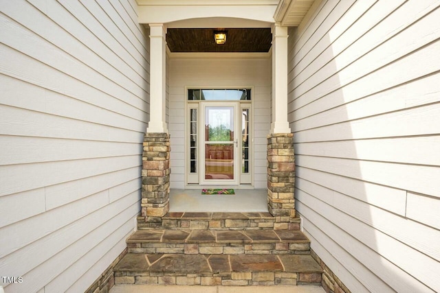 view of exterior entry featuring a porch
