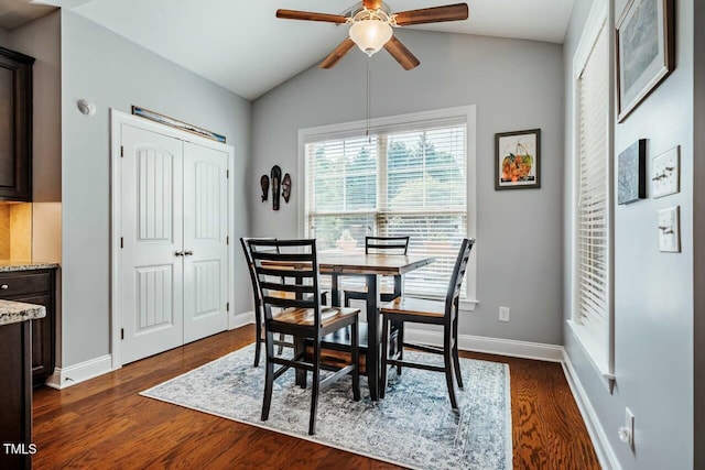 dining room with a ceiling fan, baseboards, lofted ceiling, and dark wood-style flooring