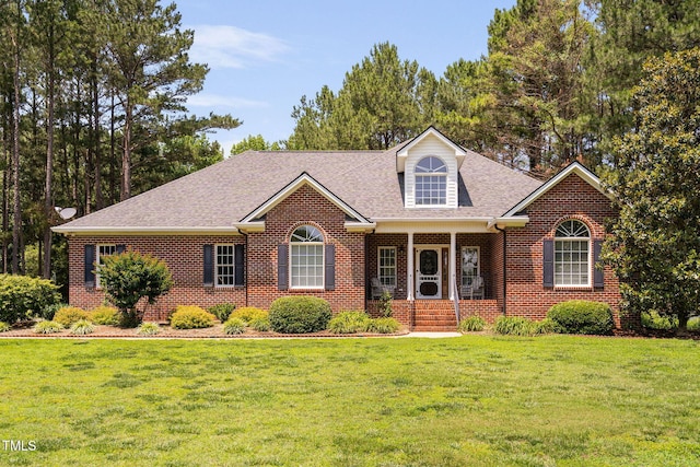 108 Cedarwood Dr, Louisburg, NC 27549 - view of front of home featuring brick siding, a front yard, and a shingled roof