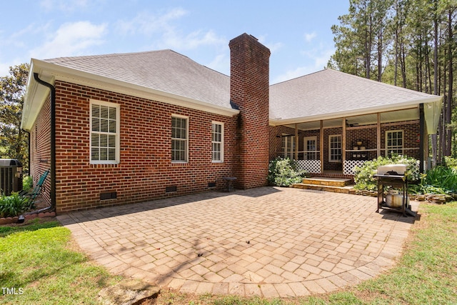108 Cedarwood Dr, Louisburg, NC 27549 - back of house featuring crawl space, a chimney, brick siding, a patio area, and roof with shingles