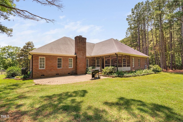 108 Cedarwood Dr, Louisburg, NC 27549 - back of house with crawl space, a chimney, a patio, brick siding, and a lawn