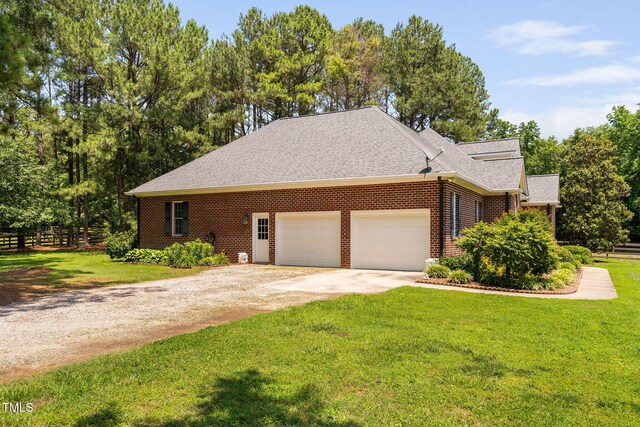 108 Cedarwood Dr, Louisburg, NC 27549 - view of property exterior featuring driveway, a garage, brick siding, and a shingled roof