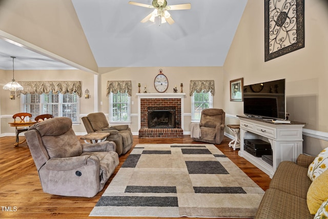 108 Cedarwood Dr, Louisburg, NC 27549 - living room featuring high vaulted ceiling, a brick fireplace, wood finished floors, ceiling fan, and baseboards