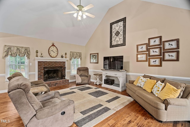 108 Cedarwood Dr, Louisburg, NC 27549 - living area with wood finished floors, ceiling fan, high vaulted ceiling, healthy amount of natural light, and a brick fireplace