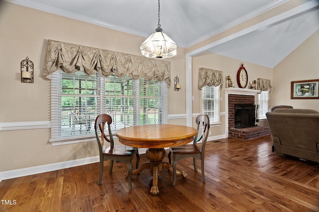 108 Cedarwood Dr, Louisburg, NC 27549 - dining area featuring a chandelier, plenty of natural light, a fireplace, wood finished floors, and crown molding