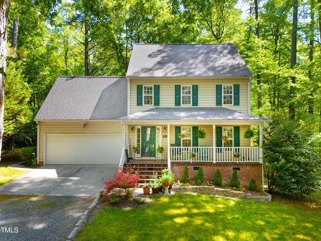 1166 NC Highway 87 N, Pittsboro, NC 27312 - colonial home featuring a front lawn, an attached garage, roof with shingles, concrete driveway, and a porch