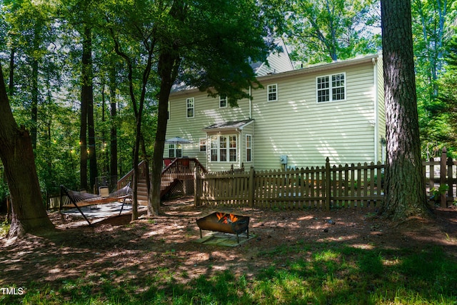 1166 NC Highway 87 N, Pittsboro, NC 27312 - rear view of property featuring fence, stairs, a fire pit, and a deck