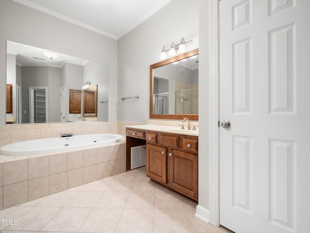 bathroom featuring vanity, ornamental molding, tile patterned floors, a shower stall, and a garden tub