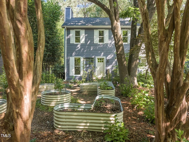 1605 Valley Run, Durham, NC 27707 - back of property with a chimney and a garden