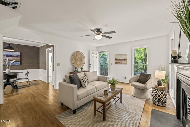 1605 Valley Run, Durham, NC 27707 - living area featuring a fireplace with flush hearth, a ceiling fan, and wood finished floors