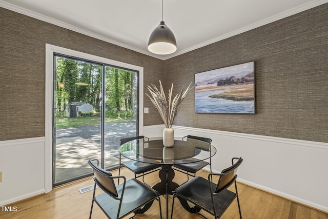 1605 Valley Run, Durham, NC 27707 - dining space with a wainscoted wall, baseboards, light wood-style floors, ornamental molding, and wallpapered walls