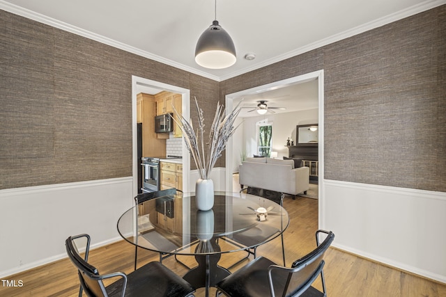 1605 Valley Run, Durham, NC 27707 - dining space with light wood-style flooring, ceiling fan, wallpapered walls, and baseboards