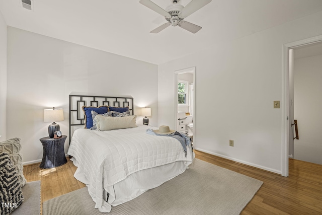 1605 Valley Run, Durham, NC 27707 - bedroom featuring wood finished floors, baseboards, ensuite bathroom, and ceiling fan